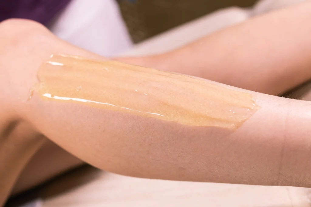 Warm wax applied evenly during a professional body wax